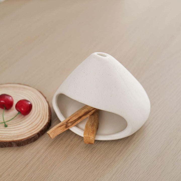 white ceramic incense cone shape burner holder on the table