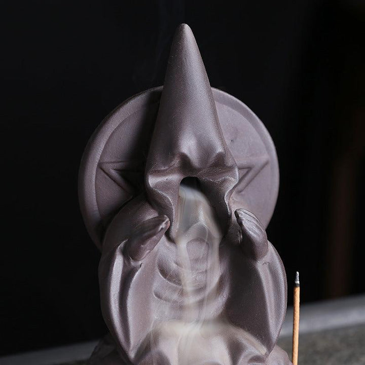 a dark gothic wizard backflow incense burner holder on the table