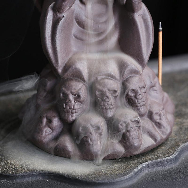 a dark gothic wizard backflow incense burner holder on the table