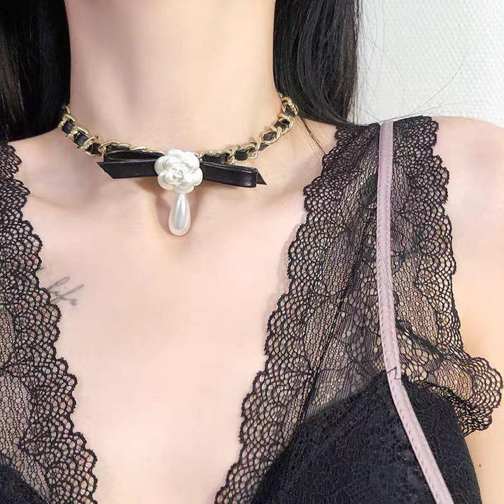 a gothic black leather buckle white rose choker