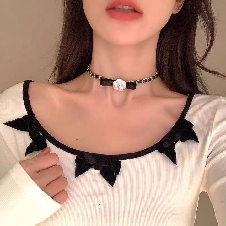 a gothic black leather buckle white rose with gold choker