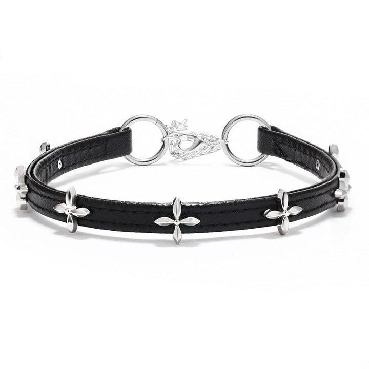 display a black gothic cross leather choker on the table