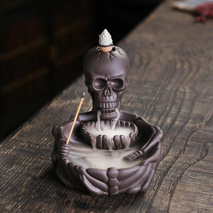 a gothic dark skeletal backflow incense burner holder