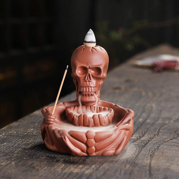 a red gothic wizard backflow incense burner holder on the table