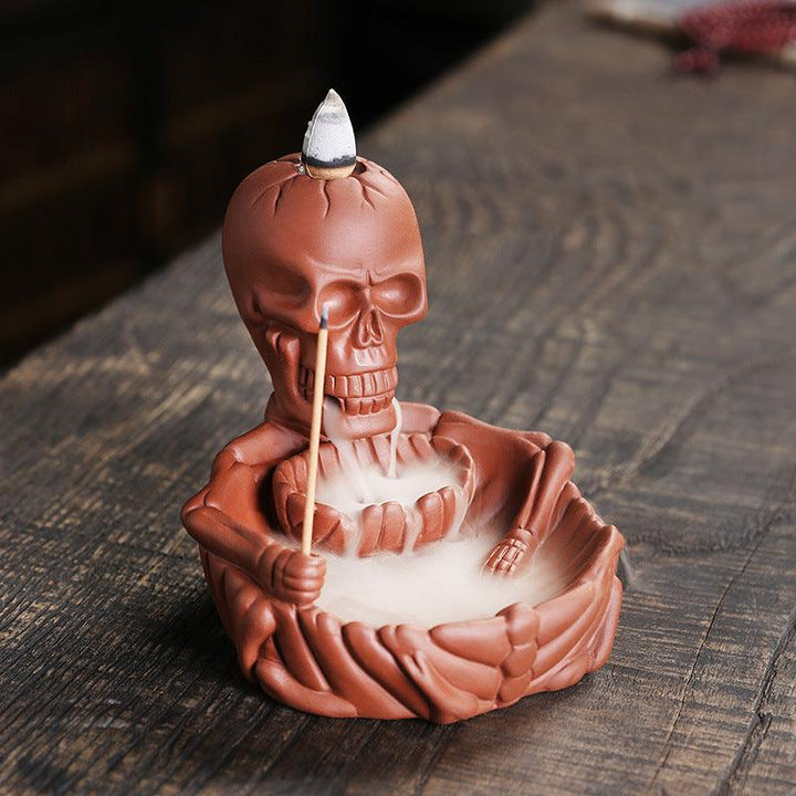 a red gothic wizard backflow incense burner holder on the table