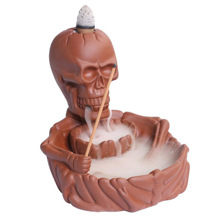 a gothic red skeletal backflow incense burner holder