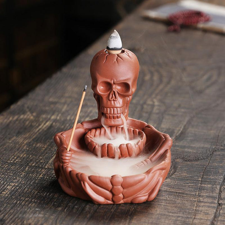 a red gothic wizard backflow incense burner holder on the table