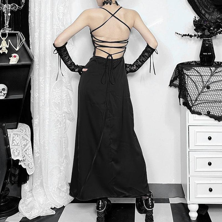 a woman wear a gothic black satin sleeveless dress with side slit