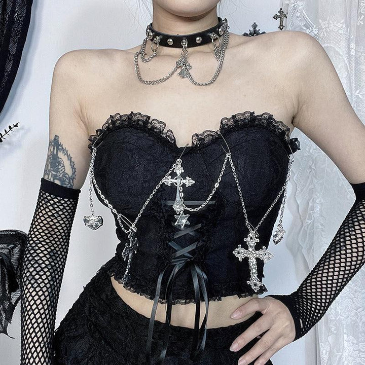 a woman wear a gothic sleeveless black cross chain strap top