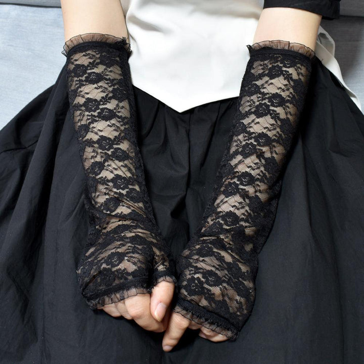 a woman wear gothic wedding black lace fingerless gloves