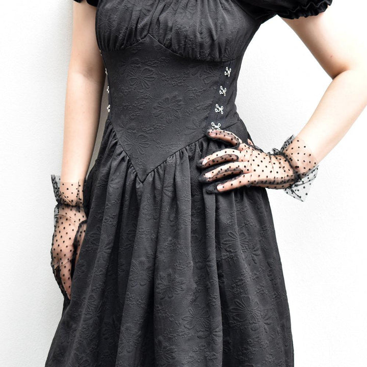 a woman wear gothic wedding mesh black and white polka dot short gloves