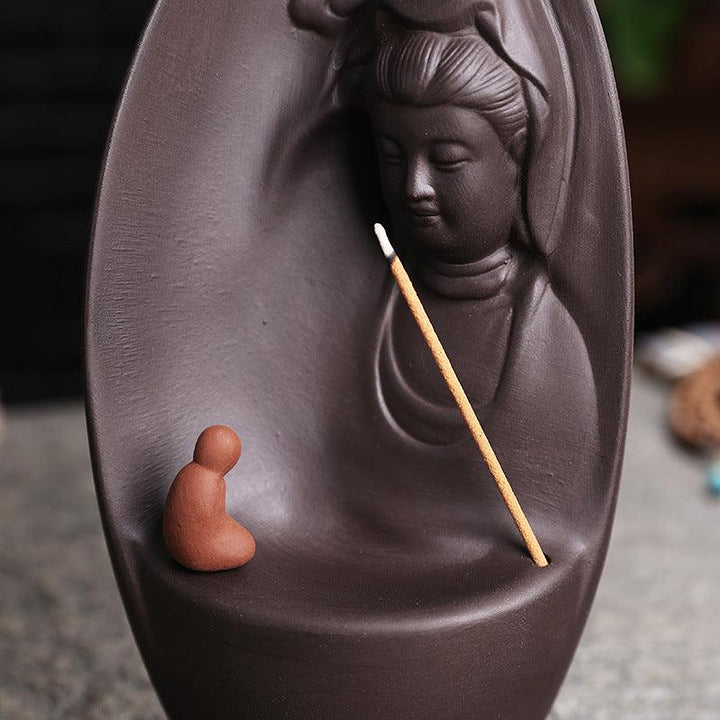 details of guanyin and buddhist monk reversing incense burner holder