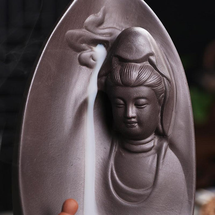 details of guanyin and buddhist monk reversing incense burner holder