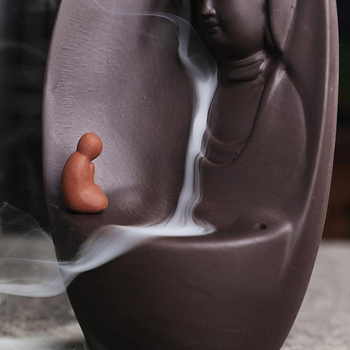 details of guanyin and buddhist monk reversing incense burner holder