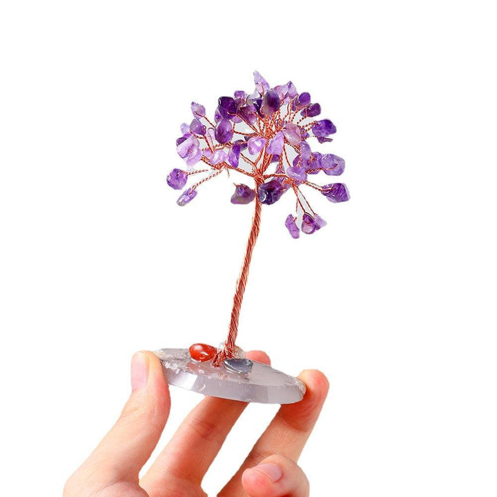 mini natural crystal bonsai tree with agate base on the hand