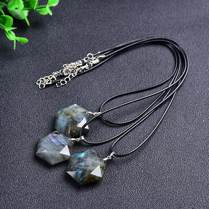 natural labradorite hexagonal crystal necklace pendant on the table