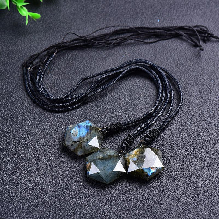 natural labradorite hexagonal crystal necklace pendant on the table