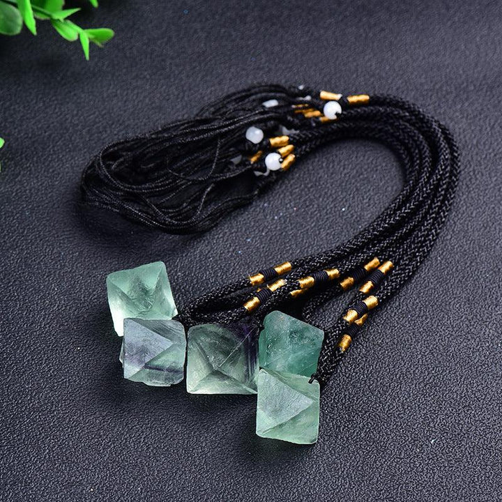 natural spirit pendulum green fluorite octahedron necklace on the table