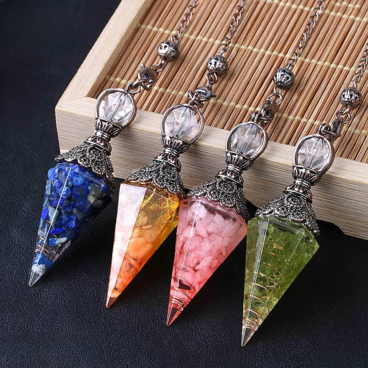 pendulum crystal healing gemstone hexagonal point pendant on the table