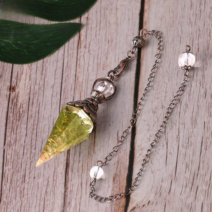 pendulum crystal healing gemstone hexagonal point pendant on the table