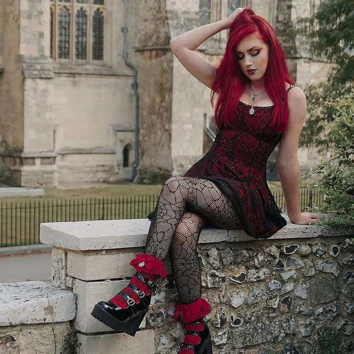 a woman wear a red and black gothic fashion corset dress